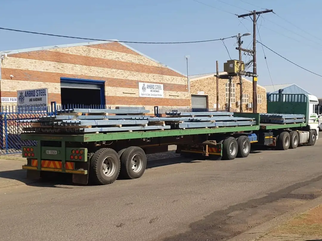Galvanised roof sheets outside an Akbro store